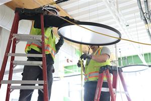 Crew installing light fixture